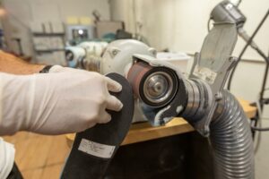 A custom orthotic having its bottom cover sanded to a specific dimension.